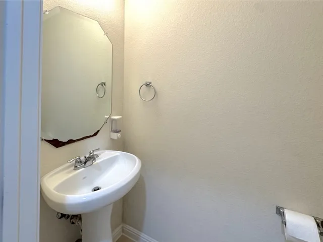 a bathroom with a sink a mirror and a toilet