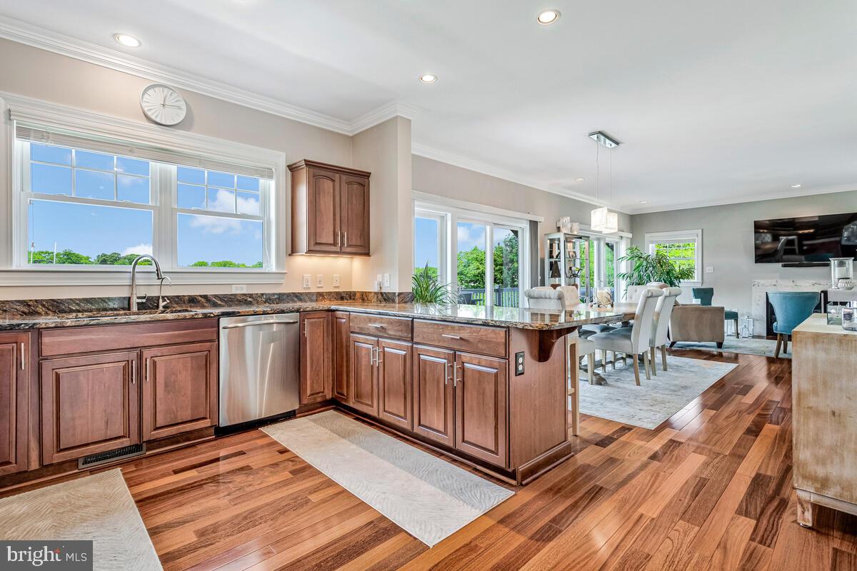 3300 Shore Drive Annapolis, MD 21403 - Photo 11 of 50 a kitchen with stainless steel appliances granite countertop sink wooden cabinets and counter space