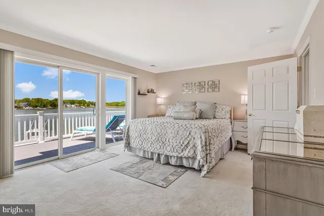 a bedroom with a balcony a bed and a balcony