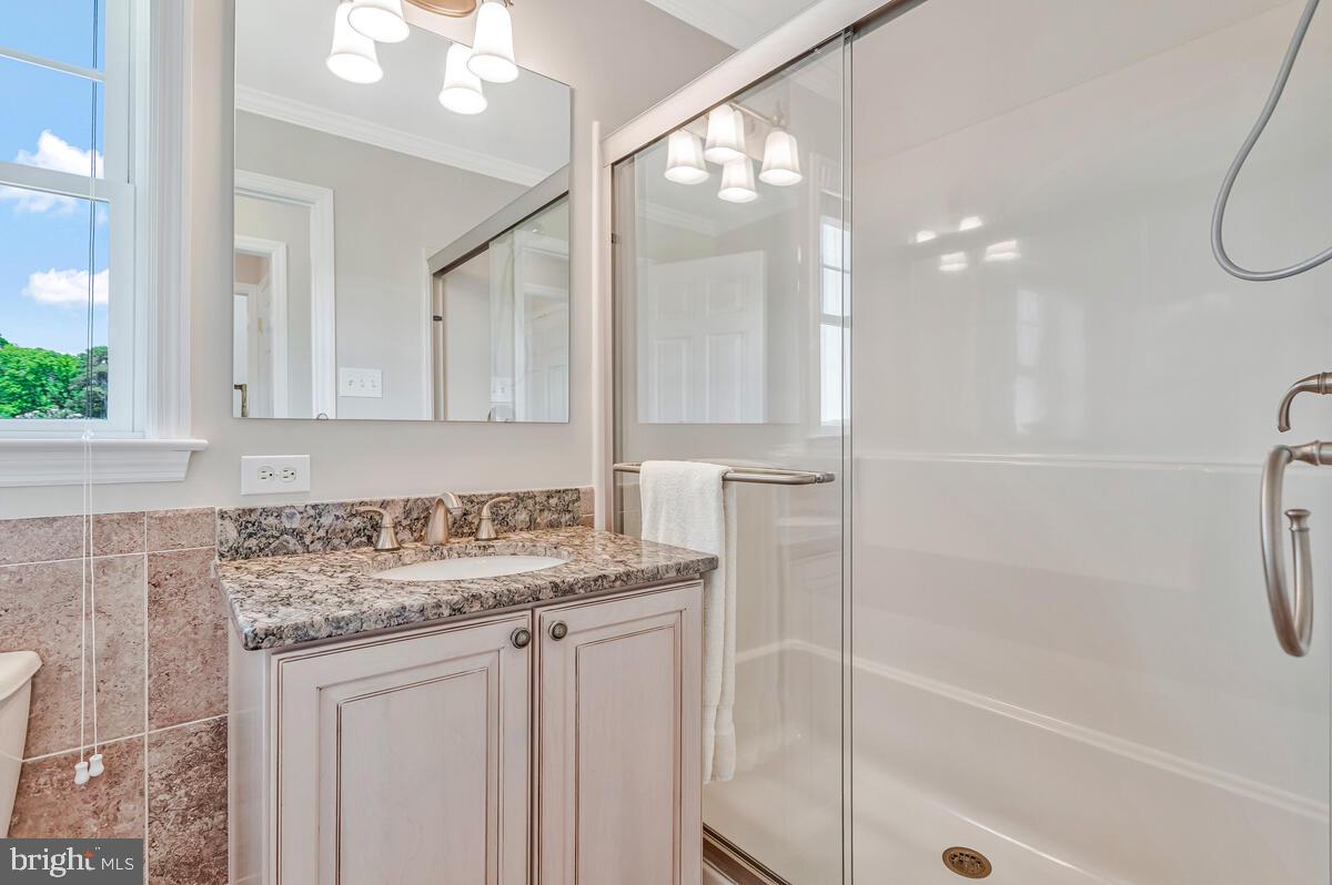 3300 Shore Drive Annapolis, MD 21403 - Photo 26 of 50 a bathroom with a sink a vanity a mirror and a shower