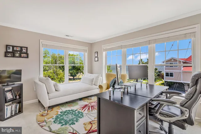 a living room with furniture a computer and a window