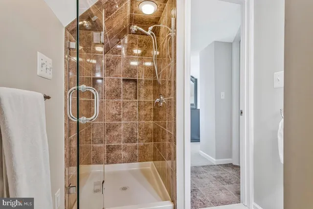 a bathroom with a glass shower door