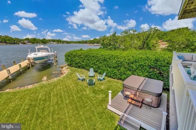 an aerial view of a house with outdoor space swimming pool and lake view