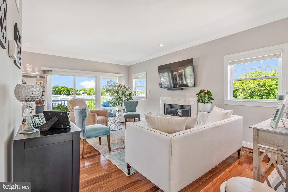 3300 Shore Drive Annapolis, MD 21403 - Photo 6 of 50 a living room with furniture a fireplace and a large window