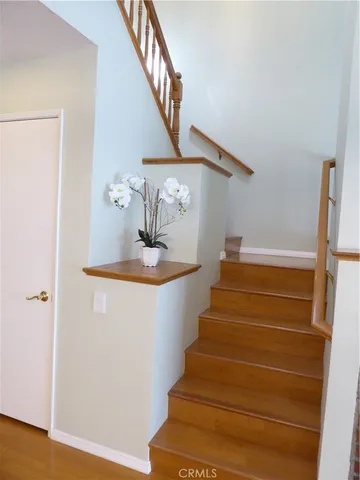 a view of entryway and hall with wooden floor