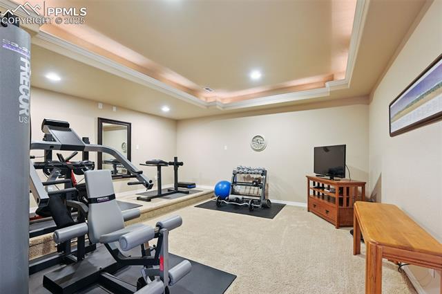 1918 Bashley Road Monument, CO 80132 - Photo 38 of 48 Workout room with a tray ceiling, crown molding, recessed lighting, and carpet floors