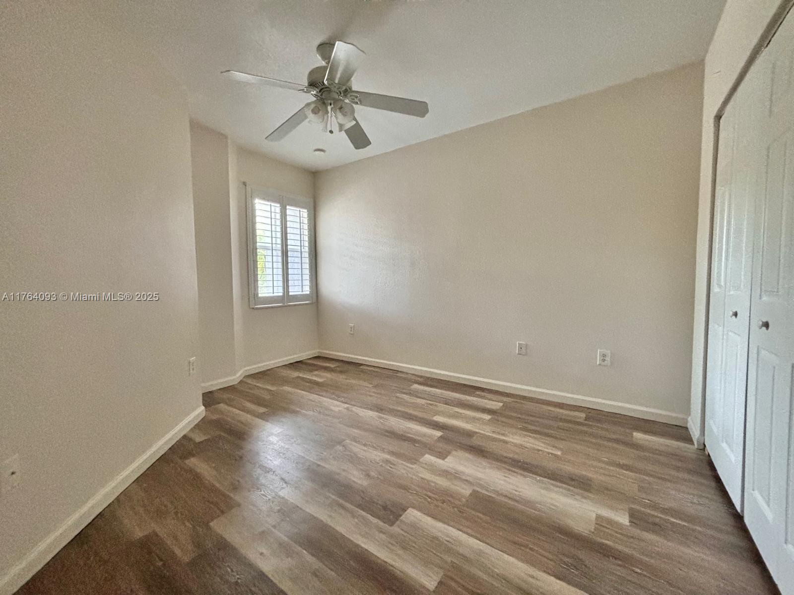8253 Southwest 29th Street, Unit 104 Miramar, FL 33025 - Photo 12 of 17 wooden floor in an empty room with a window