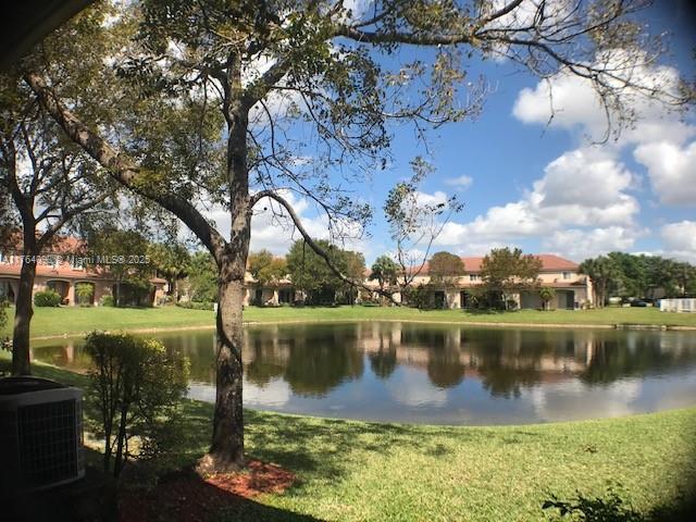 8253 Southwest 29th Street, Unit 104 Miramar, FL 33025 - Photo 16 of 17 a view of a lake with houses in the background