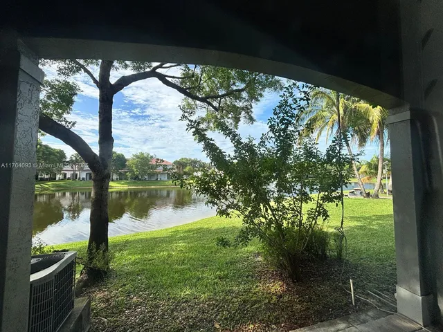 a backyard of a house with lake view and a potted plant