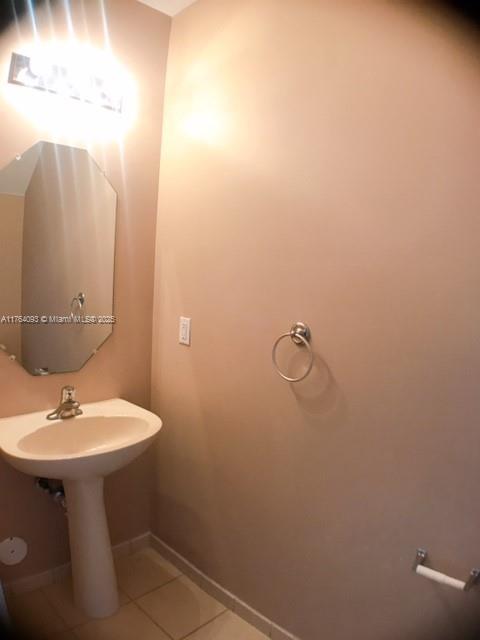 8253 Southwest 29th Street, Unit 104 Miramar, FL 33025 - Photo 6 of 17 a bathroom with a sink toilet and mirror