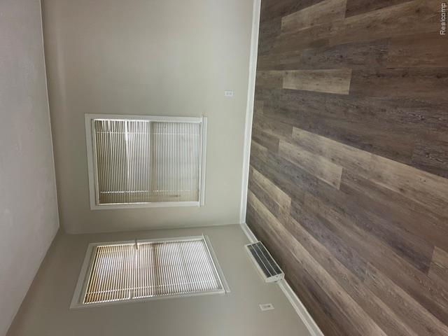 22404 Rausch Avenue Eastpointe, MI 48021 - Photo 4 of 12 Room featuring wood-finish flooring, two windows with blinds, white trim, and light-colored walls