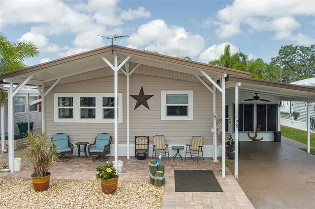 a backyard of a house with outdoor seating