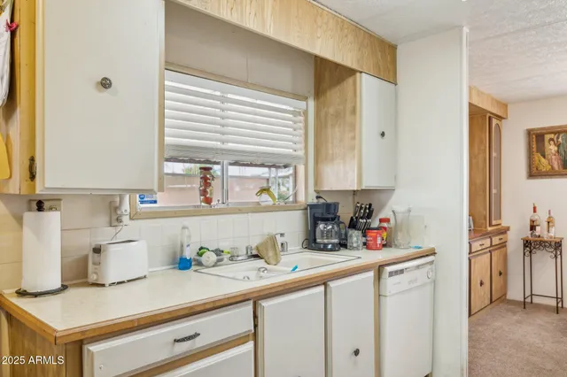 a kitchen with sink cabinets and window