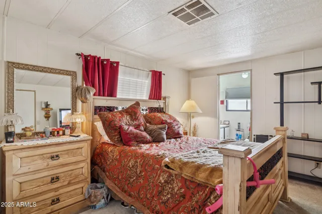 a bedroom with double bed and a dresser
