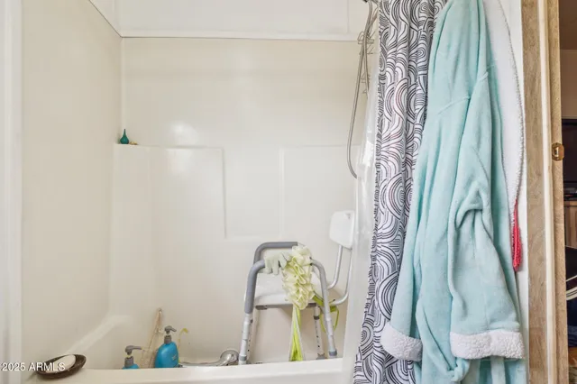 a bathroom with a shower curtain and a window