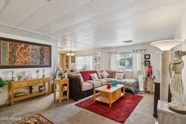 a living room with furniture a couch and large window