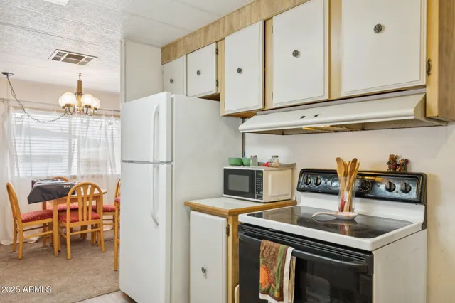 a kitchen with stainless steel appliances granite countertop a refrigerator and a stove