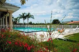 Lakes of Jacaranda Condominiums Plantation, FL 33324 - Photo 21 of 29 a view of a swimming pool with a garden and plants