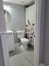 Lakes of Jacaranda Condominiums Plantation, FL 33324 - Photo 6 of 29 a bathroom with a toilet and a mirror