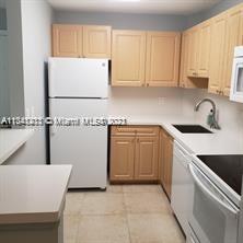 Lakes of Jacaranda Condominiums Plantation, FL 33324 - Photo 8 of 29 a kitchen with a sink stove and cabinets