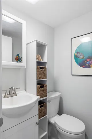 a white toilet sitting next to a bathroom sink