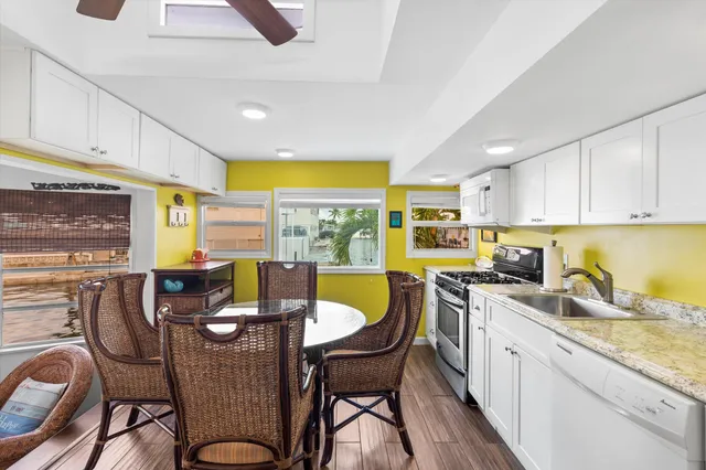 a kitchen with a table chairs stove and cabinets