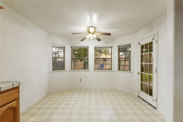 a large white kitchen with a large window