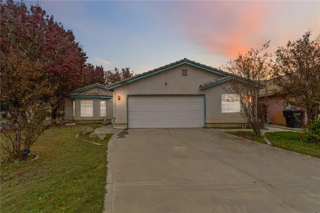 a view of a house with a yard and garage