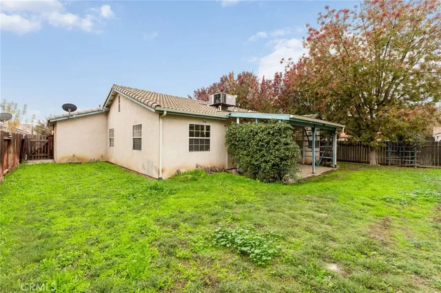 an aerial view of a house with a yard