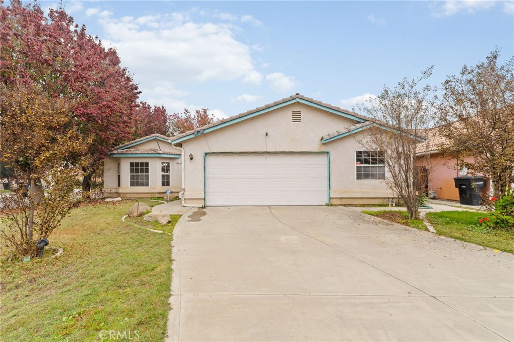 952 Upp Court Hanford, CA 93230 - Photo 4 of 35 a view of a house with a yard and large tree