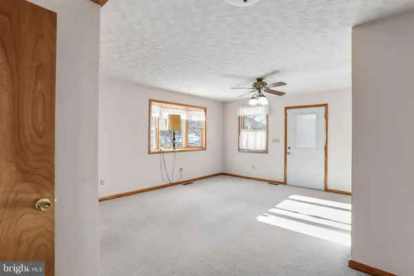 an empty room with windows and closet