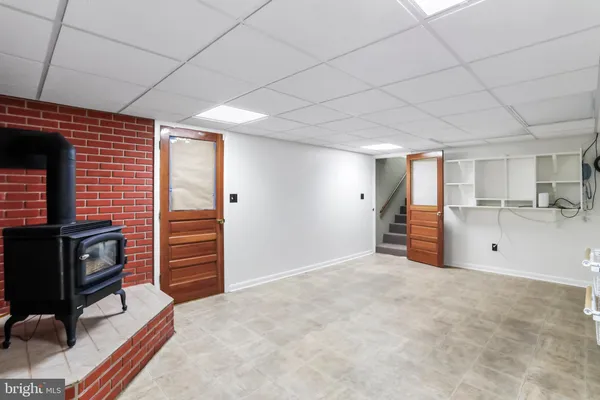 a view of an empty room with a fireplace