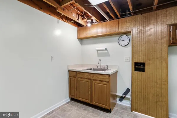 a room with a sink and a clock
