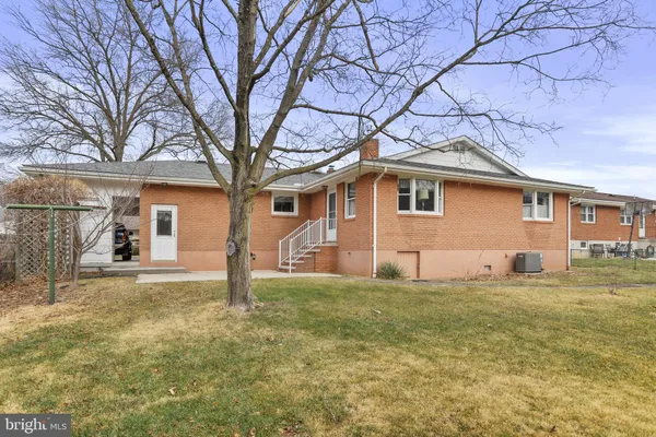 a house that has a tree in front of a house