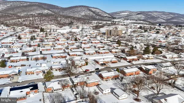 an aerial view of residential houses with city view