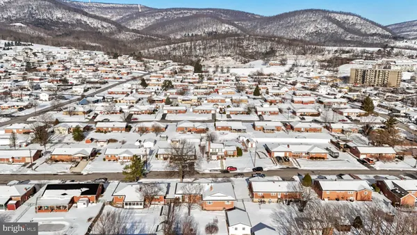 an aerial view of residential houses with city view