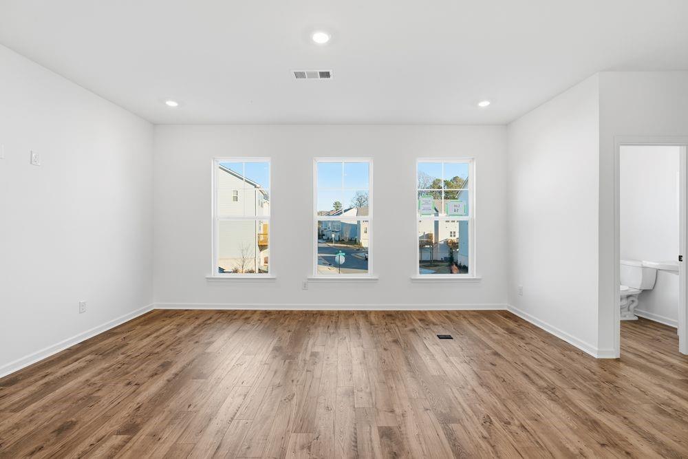5708 Schelton Place Southeast Mableton, GA 30126 - Photo 11 of 48 an empty room with wooden floor and windows