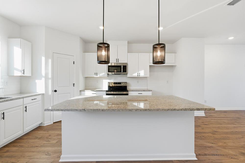 5708 Schelton Place Southeast Mableton, GA 30126 - Photo 2 of 48 a kitchen with stainless steel appliances granite countertop a sink a stove and a wooden floors