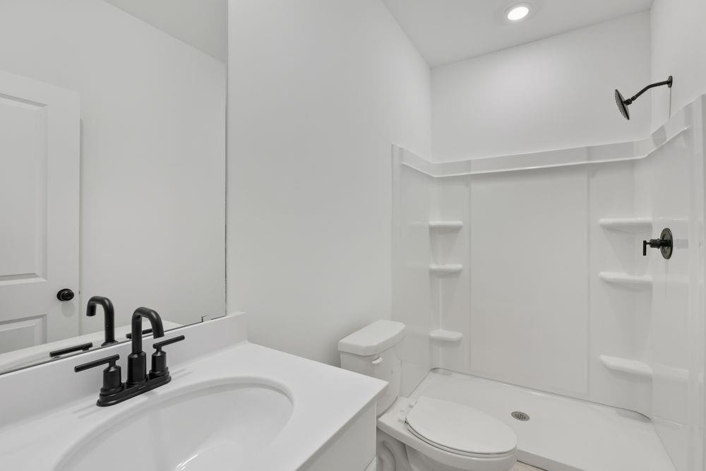 5708 Schelton Place Southeast Mableton, GA 30126 - Photo 32 of 48 a bathroom with a sink a toilet and shower