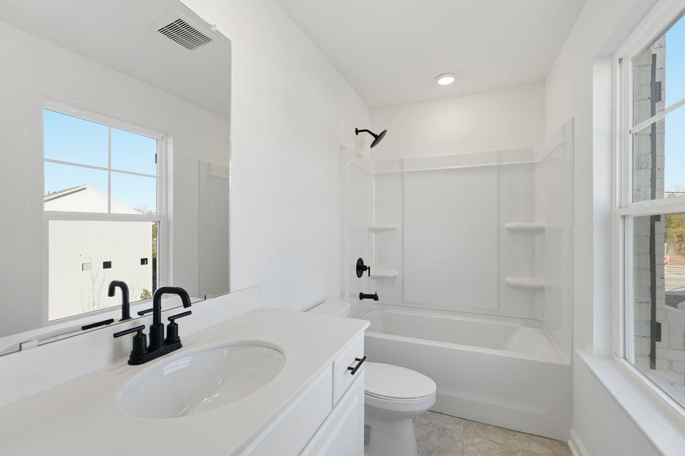 5708 Schelton Place Southeast Mableton, GA 30126 - Photo 33 of 48 a bathroom with a tub sink toilet and a mirror