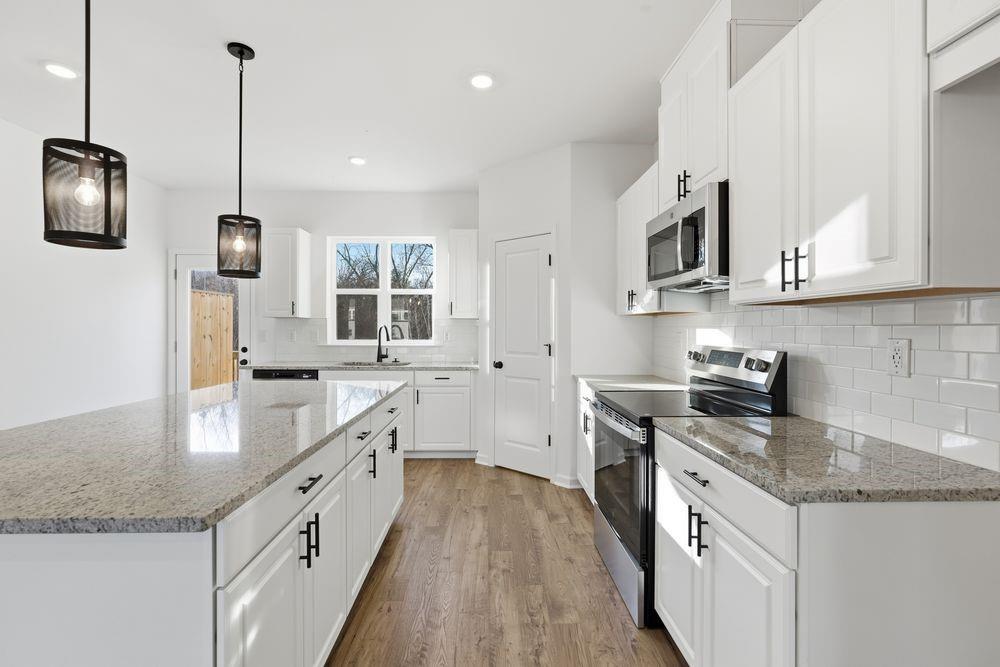 5708 Schelton Place Southeast Mableton, GA 30126 - Photo 4 of 48 a kitchen with stainless steel appliances granite countertop a sink a stove top oven a counter space and cabinets