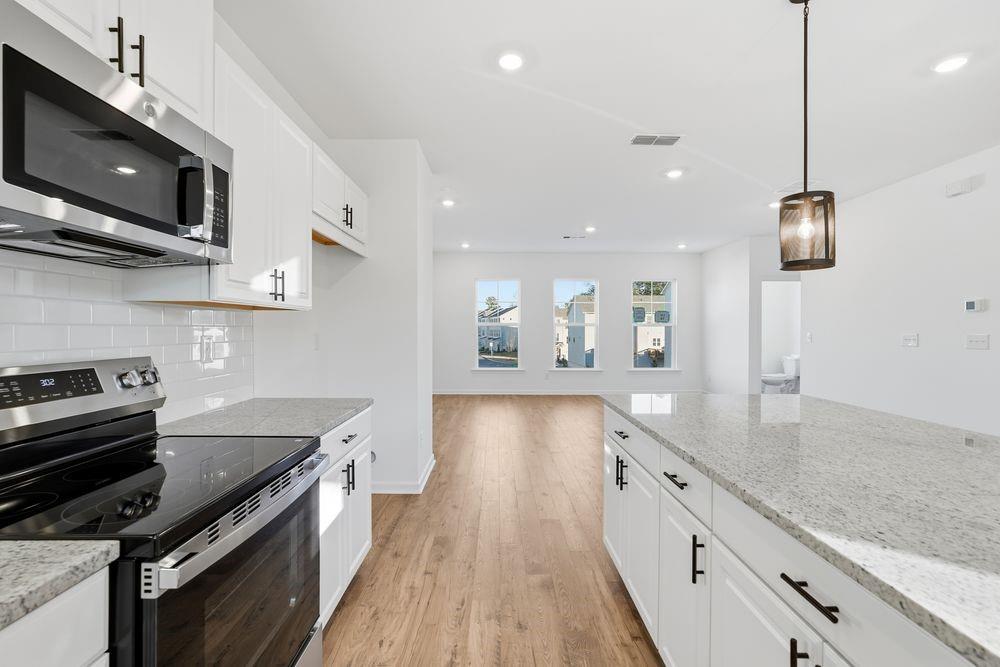 5708 Schelton Place Southeast Mableton, GA 30126 - Photo 5 of 48 a kitchen with stainless steel appliances granite countertop a stove a sink and a microwave