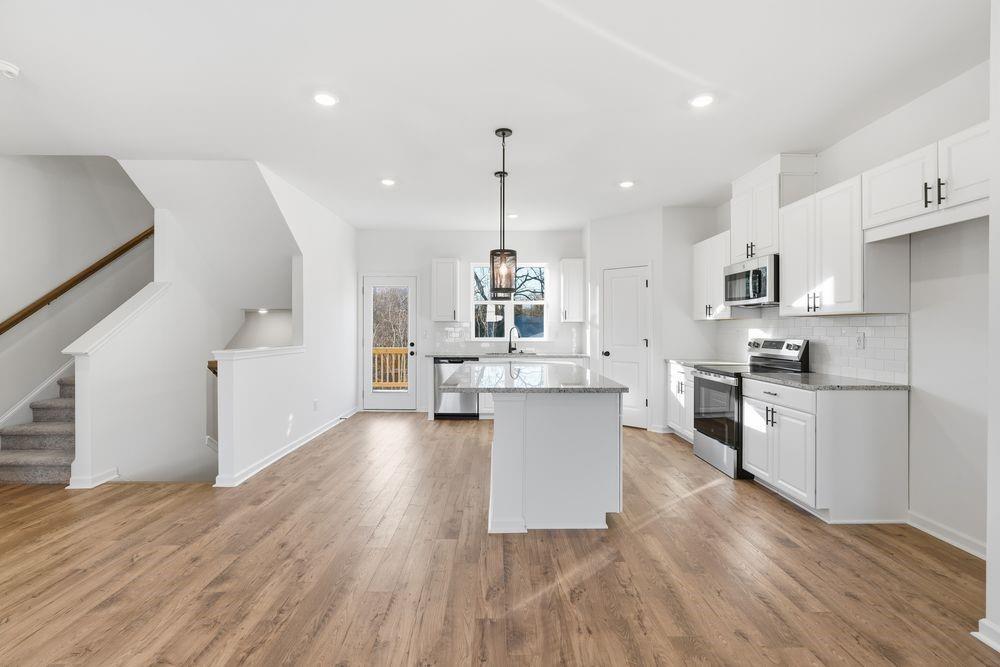 5708 Schelton Place Southeast Mableton, GA 30126 - Photo 9 of 48 a kitchen with stainless steel appliances kitchen island hardwood floor sink stove and wooden floor