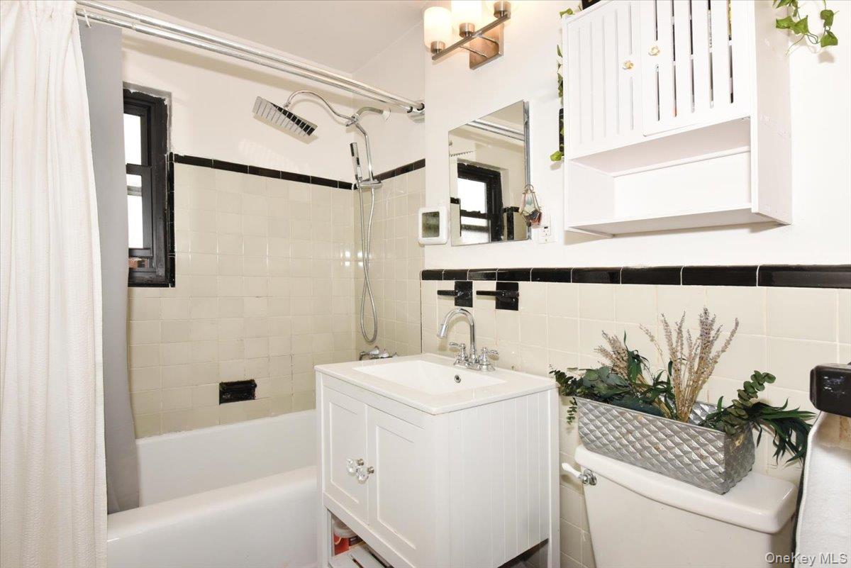 75-40 Springfield Boulevard, Unit 1 Queens, NY 11364 - Photo 13 of 18 a bathroom with a sink and a mirror