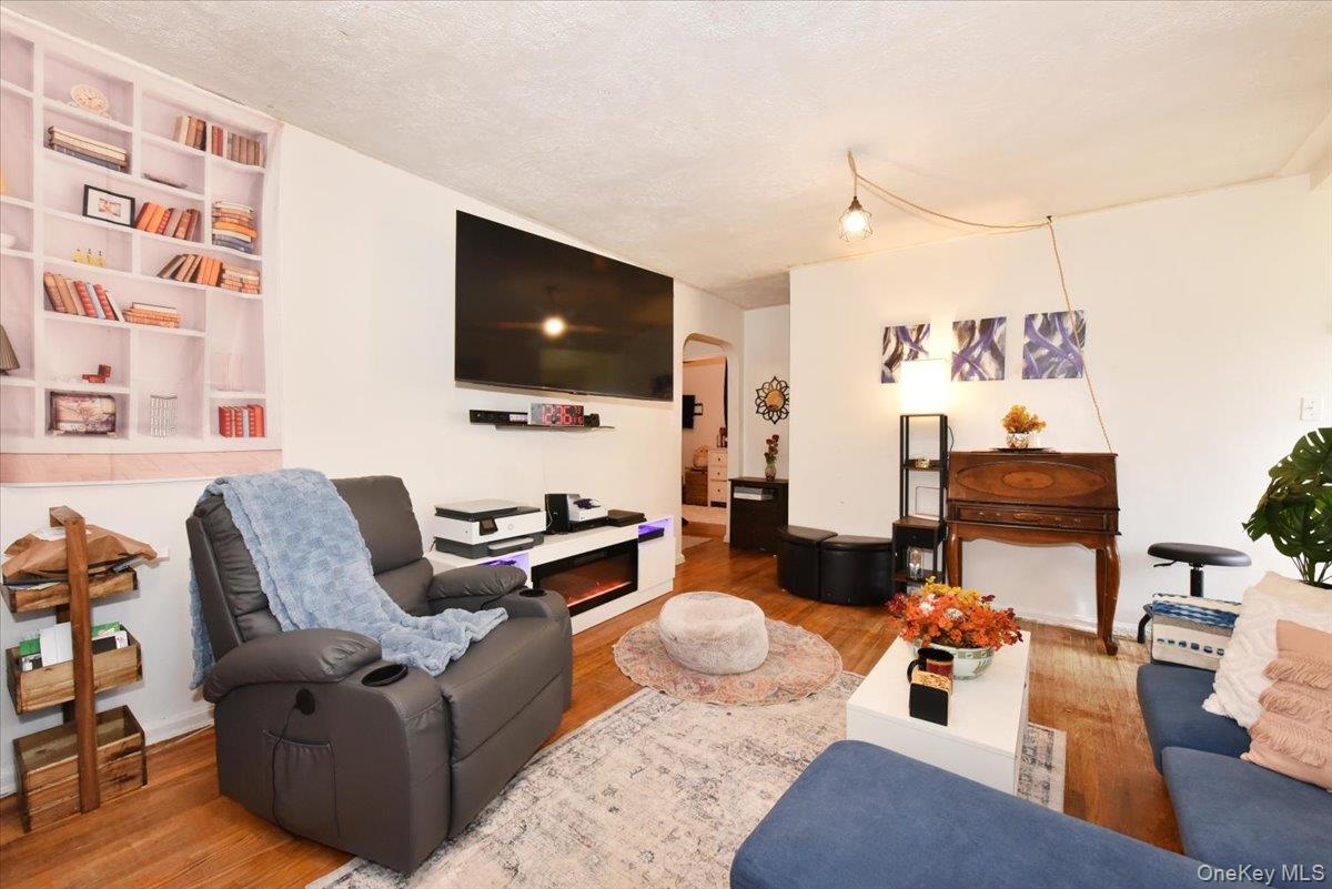 75-40 Springfield Boulevard, Unit 1 Queens, NY 11364 - Photo 3 of 18 a living room with furniture and a flat screen tv