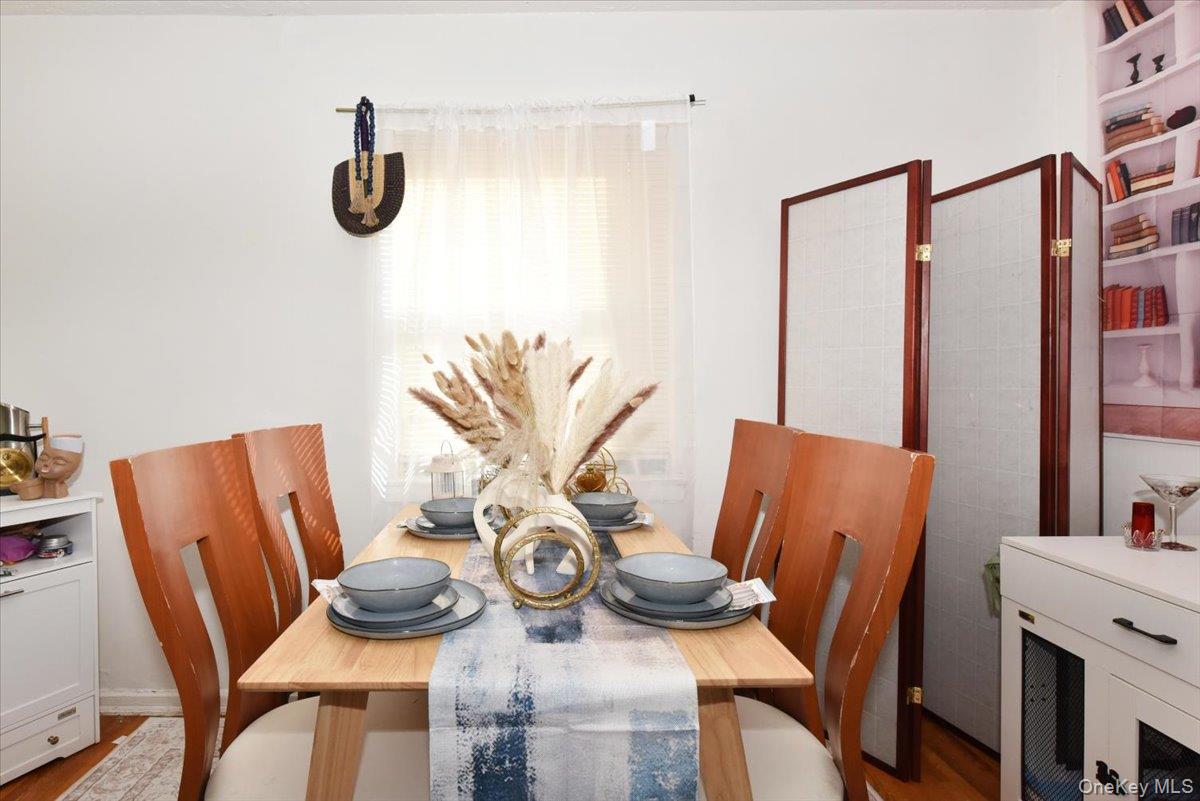 75-40 Springfield Boulevard, Unit 1 Queens, NY 11364 - Photo 7 of 18 a view of a dining room with furniture and wooden floor