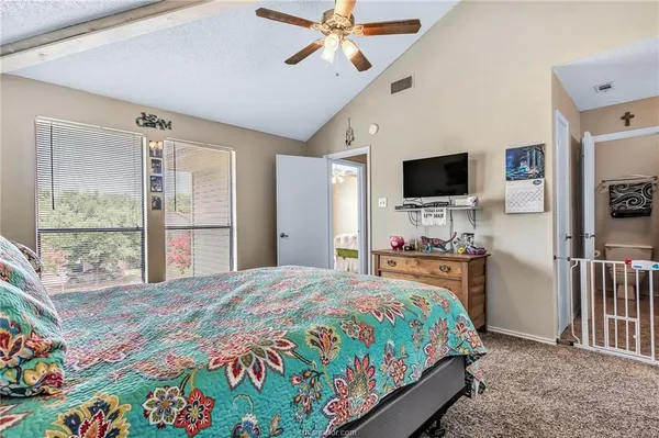 a bedroom with a bed and a flat screen tv