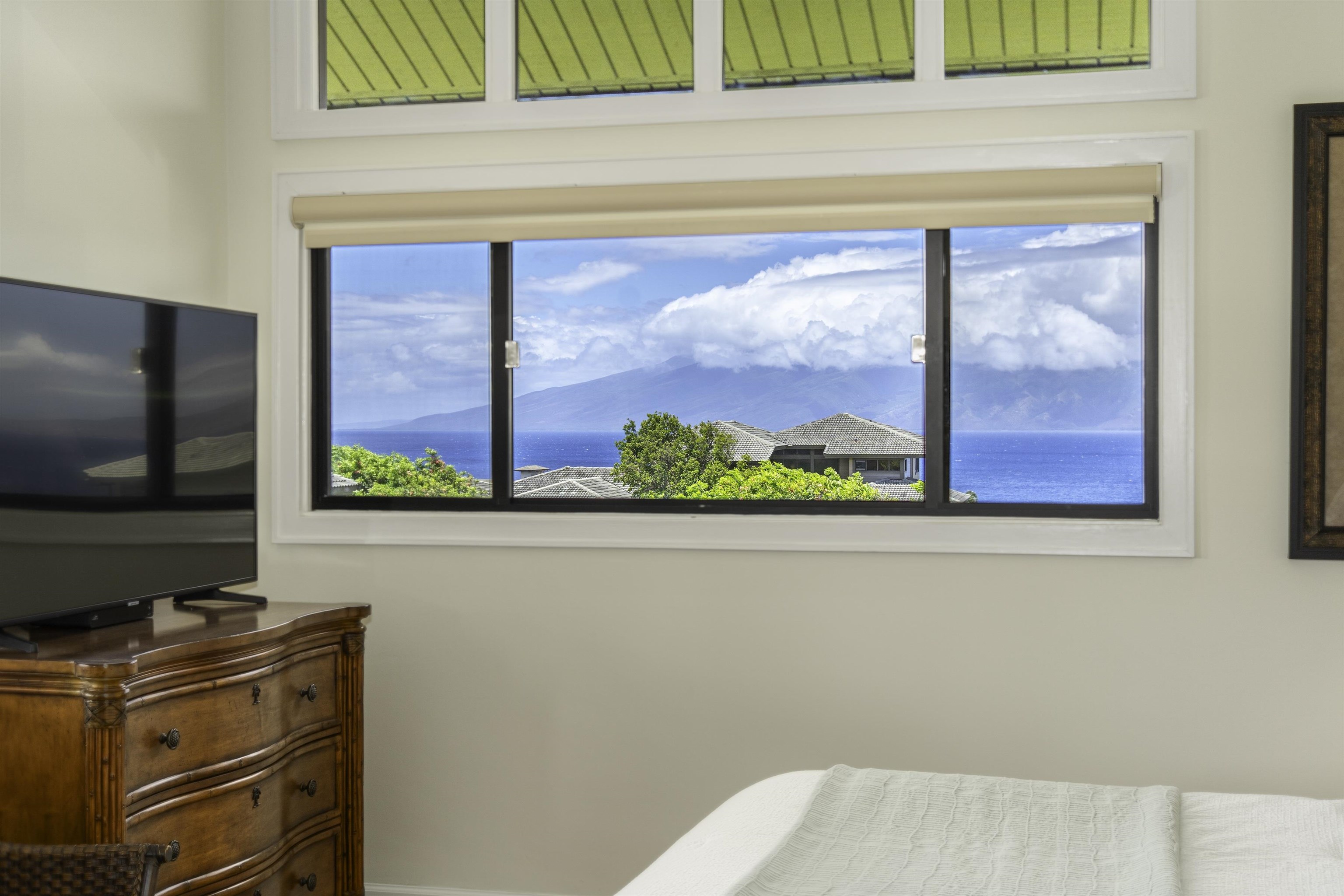 100 Ridge Road, Unit 232324 Lahaina, HI 96761 - Photo 20 of 50 a living room with a flat screen tv and a floor to ceiling window