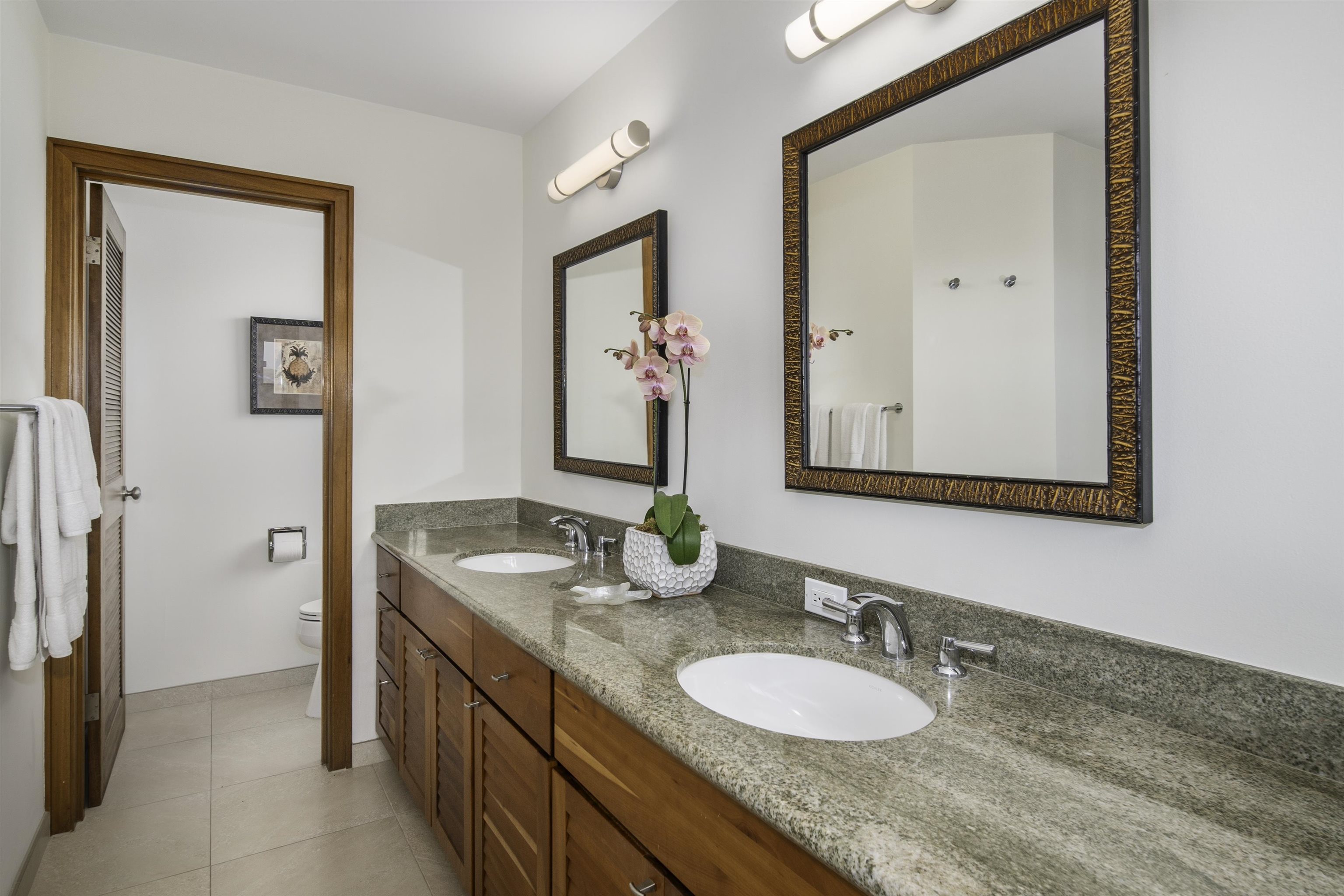 100 Ridge Road, Unit 232324 Lahaina, HI 96761 - Photo 32 of 50 a bathroom with a granite countertop sink and a mirror
