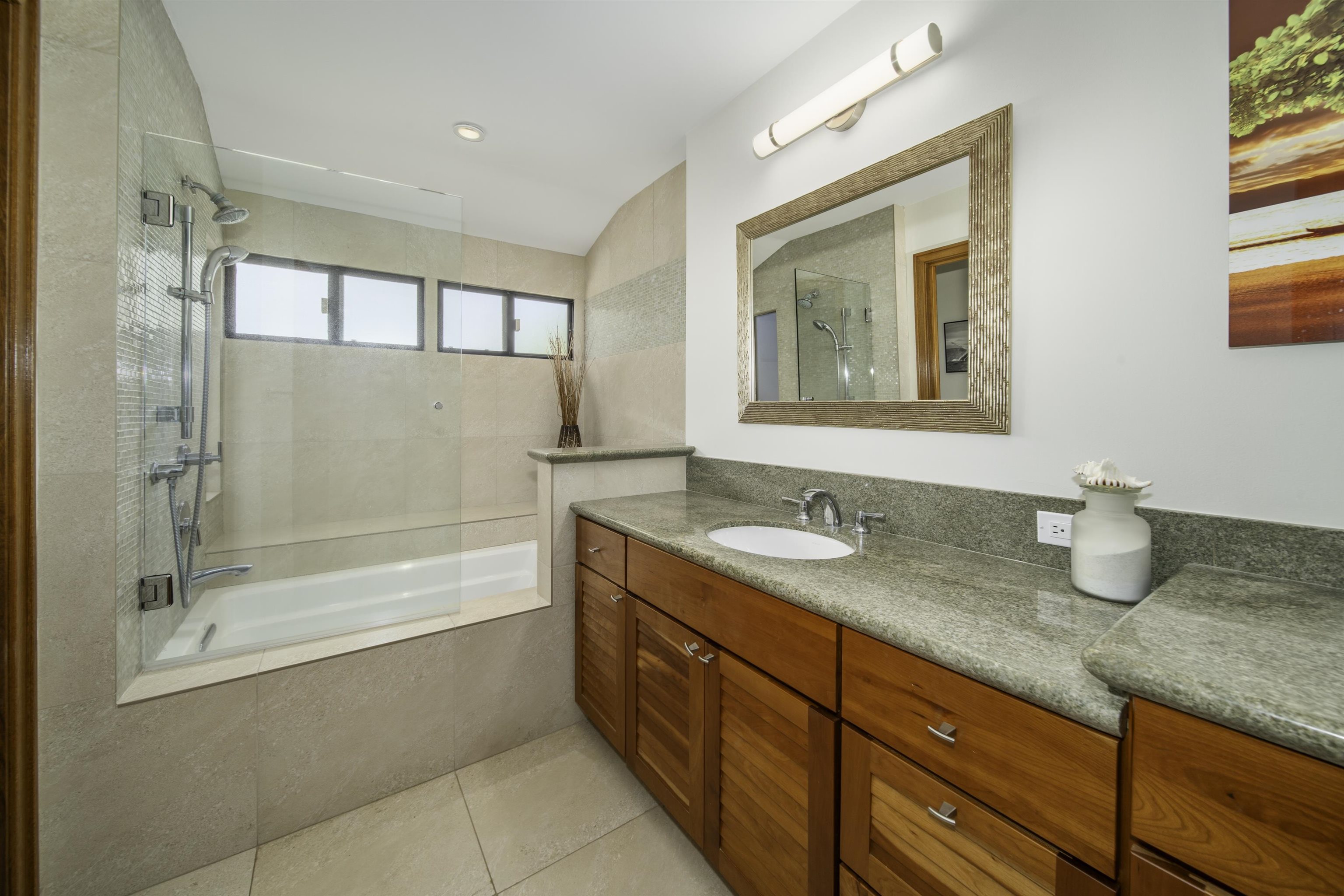 100 Ridge Road, Unit 232324 Lahaina, HI 96761 - Photo 39 of 50 a bathroom with a granite countertop sink mirror and a bathtub